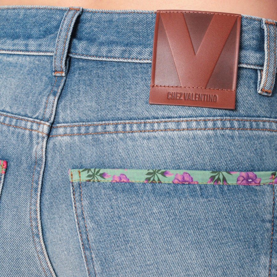 Valentino Washed blue jeans with floral fabric trims