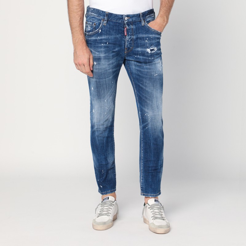 Faded blue jeans with rips and splashes